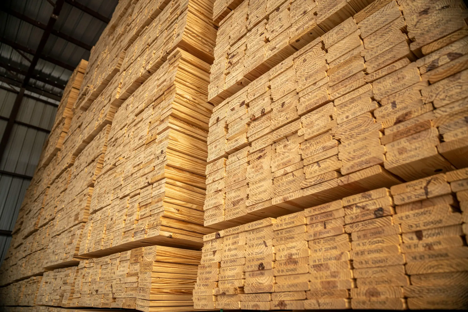 Wall of banded sawn lumber packs stacked to the roof of a warehouse